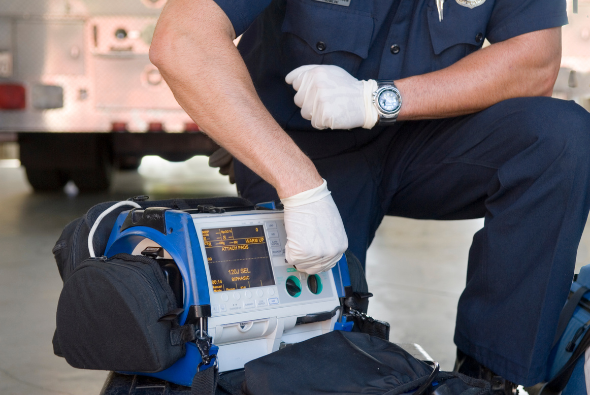 Paramedic Demonstrating a Portable Defibrillator